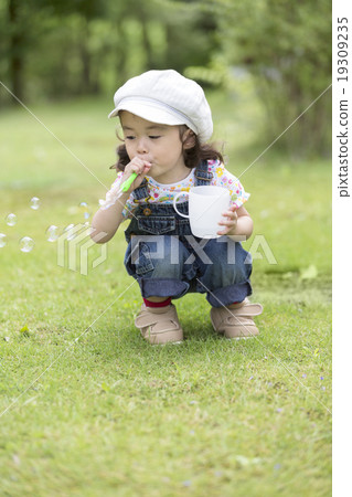 Girls blowing soap bubbles 19309235