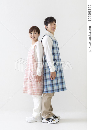 A pair of nursery teachers standing back to back A pair of nursery teachers standing back to back 19309362