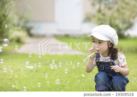 Girls blowing soap bubbles 19309528