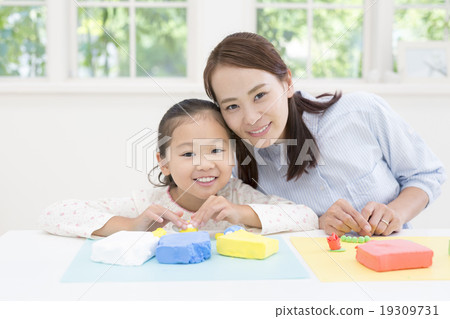 Mother and daughter playing with clay 19309731
