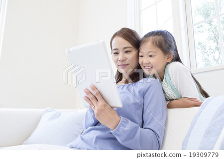 Mother and daughter looking at tablet PC 19309779