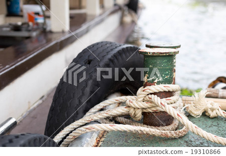 Boat rope tied to the old iron cleats 19310866