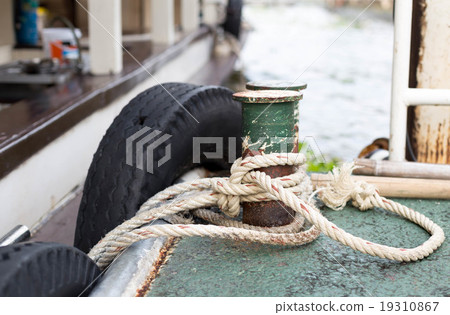 Boat rope tied to the old iron cleats 19310867