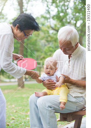chinese grandfather and grandmother playing with baby grandson a 19311400