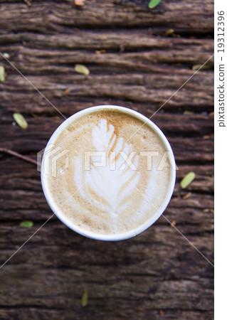 A Cup of hot latte art coffee on wooden table 19312396