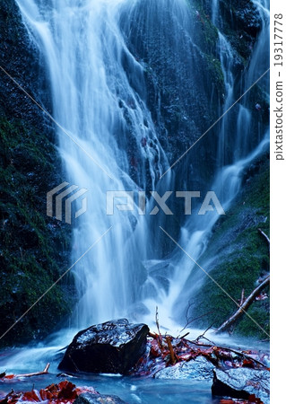 Waterfall on mountain stream. Broken branches 19317778