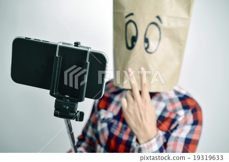 man with a paper bag in his head taking a selfie man with a paper bag in his head taking a selfie 19319633