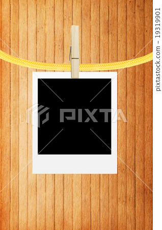 photo frame with clothespin over wooden background 19319901