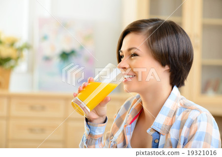 Young girl drinking orange juice.  Young girl drinking orange juice.  19321016