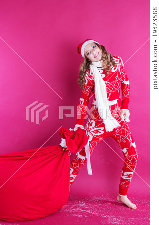 Santa girl is holding big red christmas bag Santa girl is holding big red christmas bag 19323588