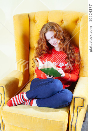 Happy woman relaxing at home and reading a book 19324377