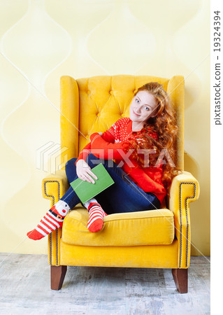 Happy woman relaxing at home and reading a book Happy woman relaxing at home and reading a book 19324394