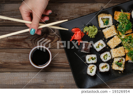 Sushi. Hand with chopsticks Sushi. Hand with chopsticks 19326954