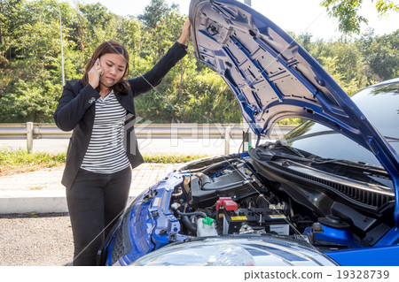 Asian women calling after breaking down car  19328739