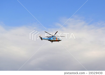A helicopter flying in the sky 19329430