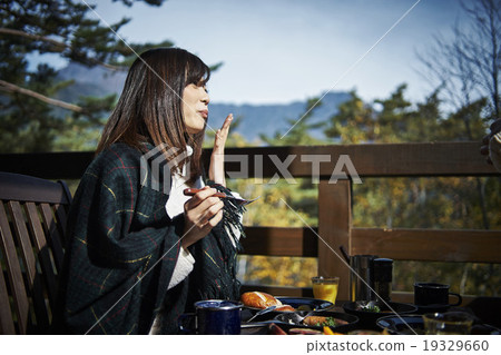 A woman enjoying a meal A woman enjoying a meal 19329660