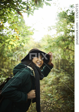 A woman walking through the forest 19329735