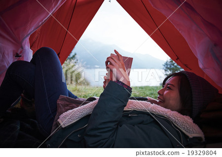 A woman relaxing in a tent 19329804