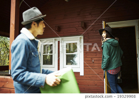Male carrying a cooler box to the lodge 19329908