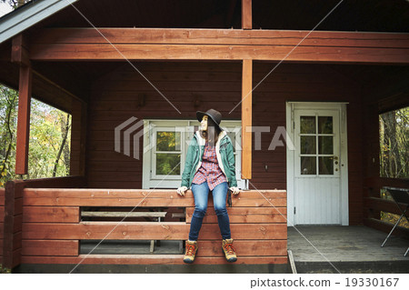 A woman relaxing at a lodge 19330167