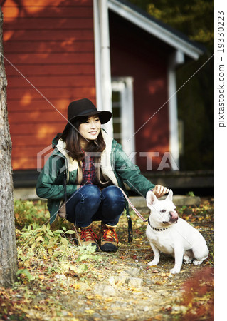 A woman stroking a pet dog A woman stroking a pet dog 19330223