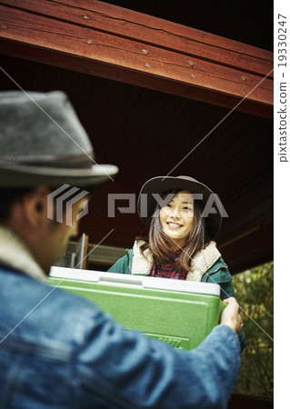 Man carrying a cooler box Man carrying a cooler box 19330247