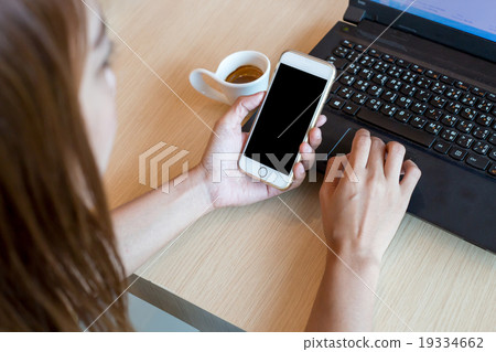 Woman using a touch screen of white smartphone Woman using a touch screen of white smartphone 19334662