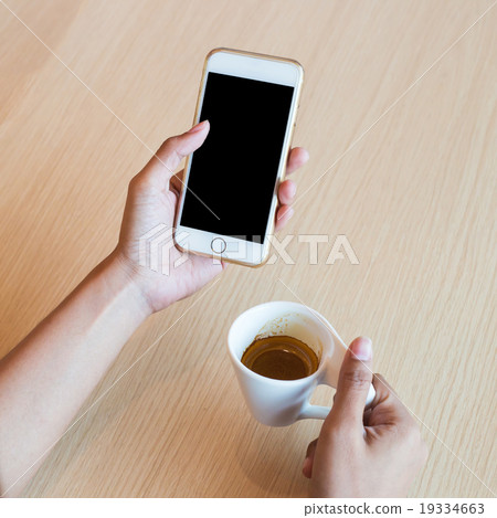 Hand using a touch screen of white smartphone Hand using a touch screen of white smartphone 19334663