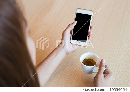 Woman using a touch screen of white smartphone Woman using a touch screen of white smartphone 19334664