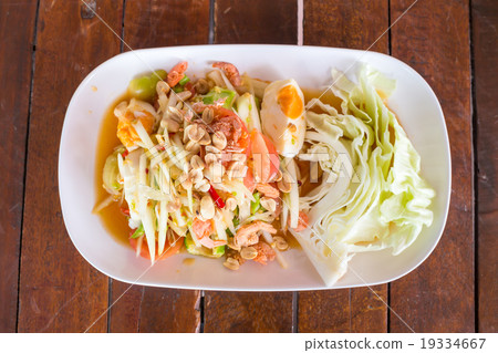 Green papaya salad with salted egg on wood table Green papaya salad with salted egg on wood table 19334667