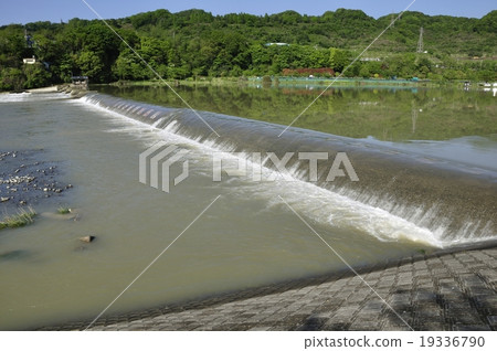 Weir of river which increased due to rain 19336790