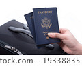 Hand holding US passport 19338835