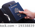 Hand holding US passport 19338839