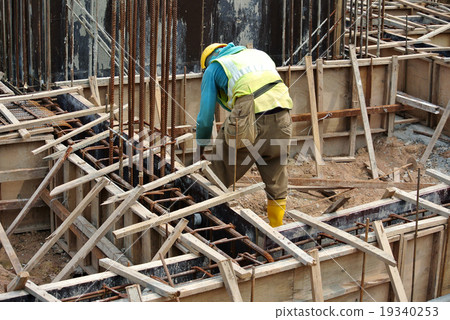 Workers fabricating ground beam formwork Workers fabricating ground beam formwork 19340253