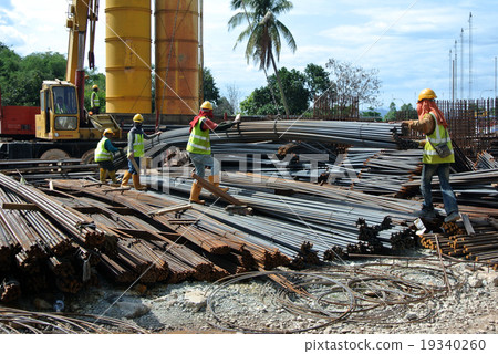 Workers lifting bundle of reinforcement bar Workers lifting bundle of reinforcement bar 19340260