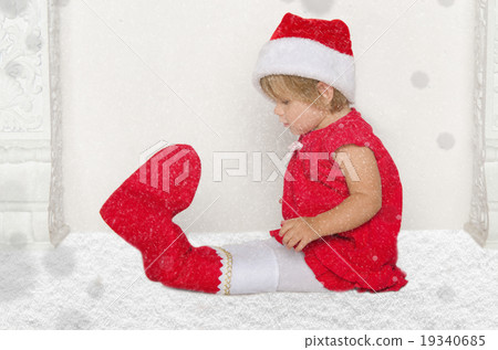 Small child in Santa suit sitting on floor with snow Small child in Santa suit sitting on floor with snow 19340685