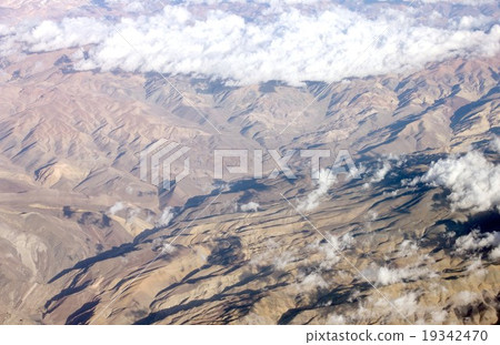 Andean mountain range which crosses the South American continent north and south, An intricate valley is seen from the clouds 19342470