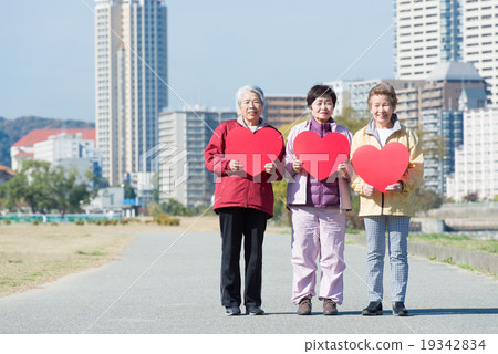 Three Japanese elderly people standing with a red heart mark Three Japanese elderly people standing with a red heart mark 19342834