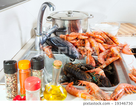 raw sea foods at sink in kitchen 19346730
