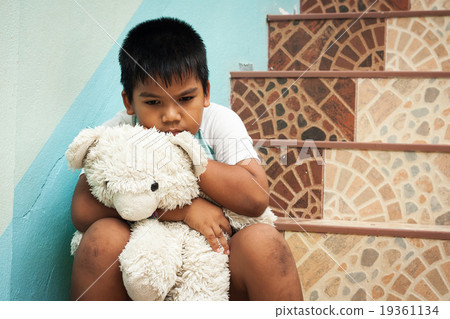 little boy sitting alone at staircase in the park 19361134