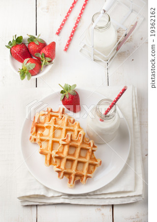 Fresh waffles, bottle of milk Breakfast table Fresh waffles, bottle of milk Breakfast table 19362162