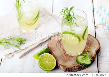 Lime cucumber lemonade cocktail on a white table 19363074