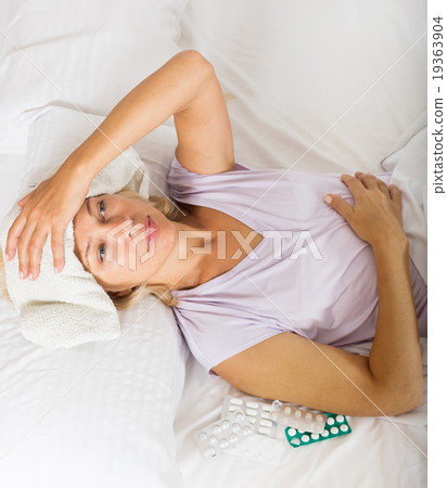 Mature woman laying in bed with towel 19363904