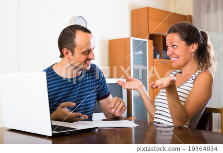 Two colleagues with documents at office. Two colleagues with documents at office. 19364034