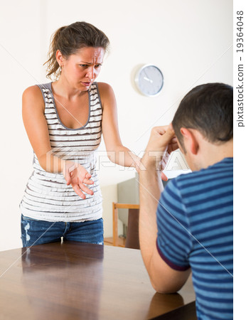 family couple shouting while arguing indoors family couple shouting while arguing indoors 19364048