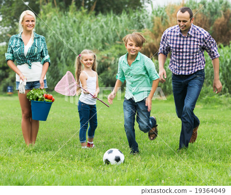 Family running with ball Family running with ball 19364049