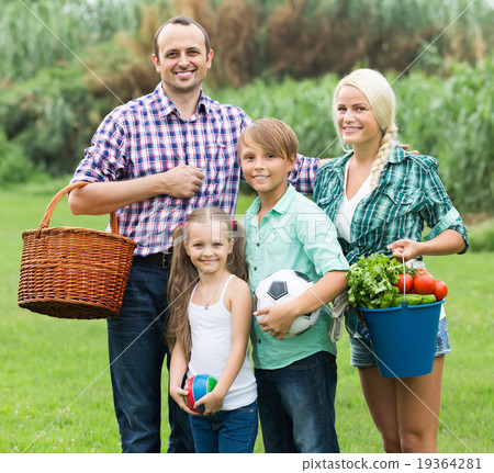 Family of four resting at countryside. 19364281