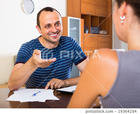 Two colleagues with documents at office. Two colleagues with documents at office. 19364284