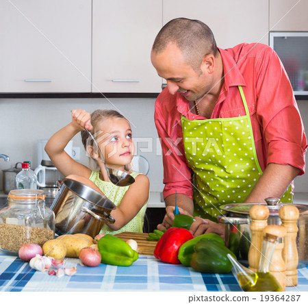 Man with little daughter at kitchen. 19364287