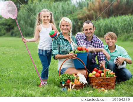 Parents with two children at the lawn. 19364289